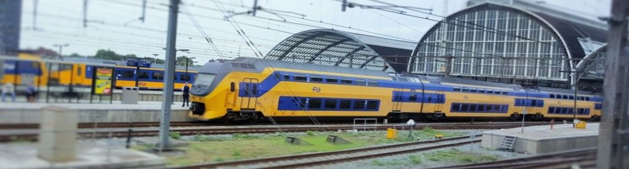 An NS VIRM train departs from Amsterdam