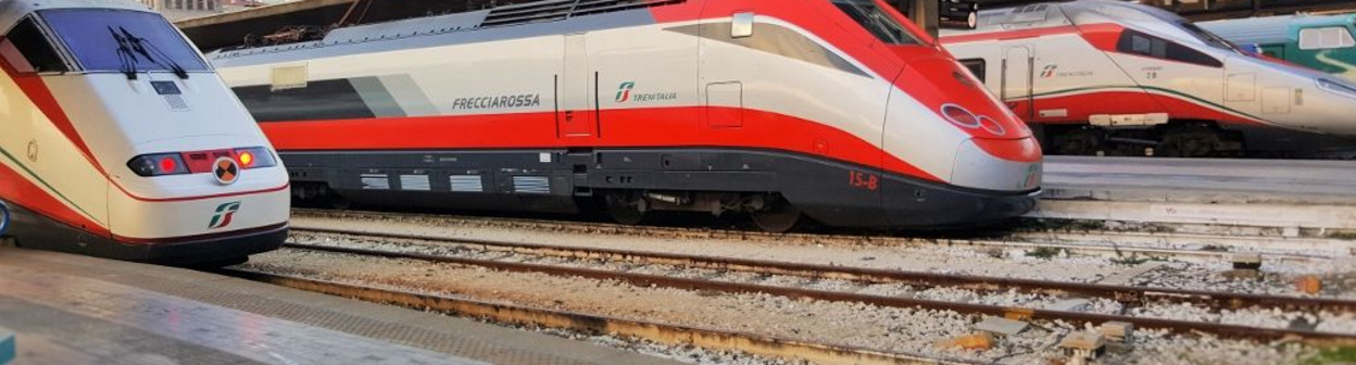A Frecciabianca train on the left, a Frecciarossa in the center and a Frecciargento on the right