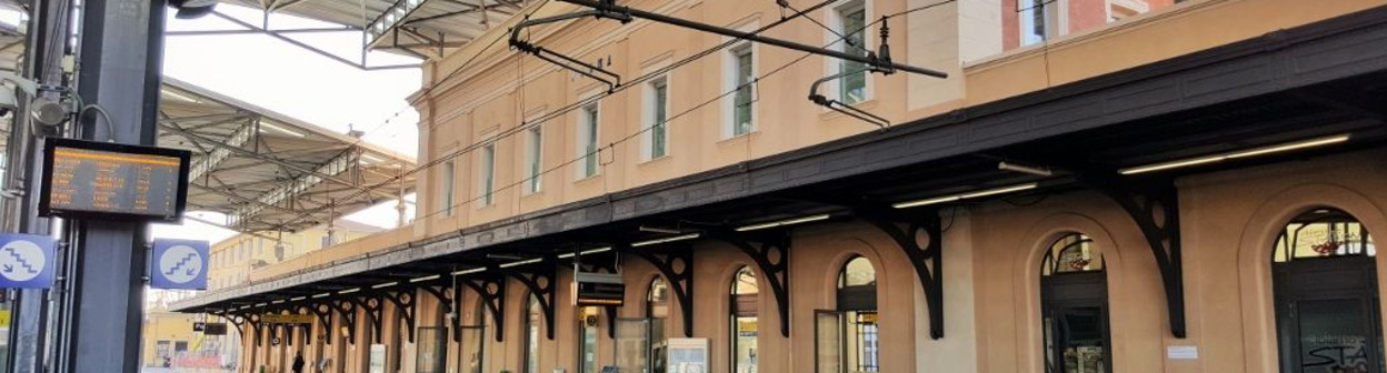 A roof spans the platforms/tracks at Parma station