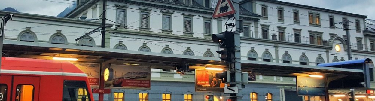 An MGB train departs in front of Brig station