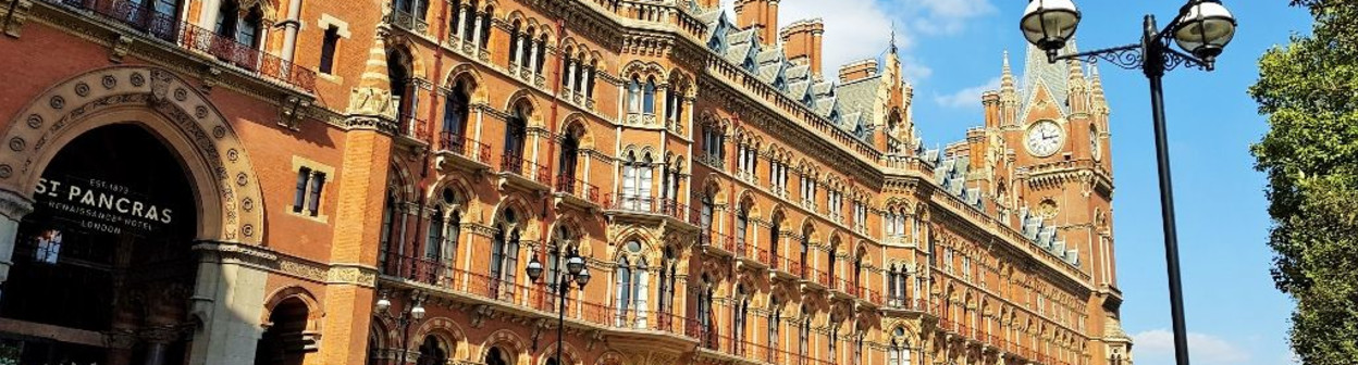 The magnificence of St Pancras station on Euston Road, the most romantic entrance is the arch by the red car