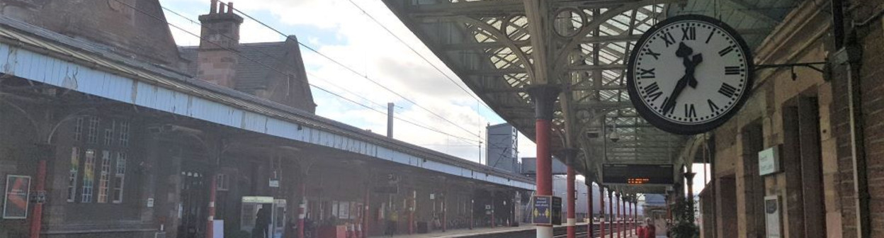 By the clock on the northbound platform is the entrance to a subway, which is the quickest route to the exit