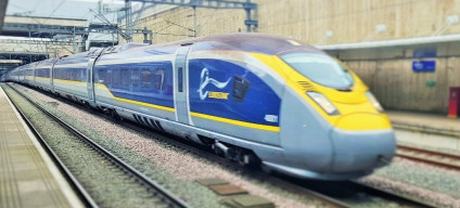 A Eurostar e320 train races through Stratford International station