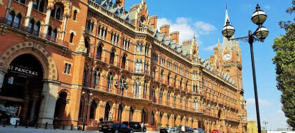 The magnificence of St Pancras station on Euston Road, the most romantic entrance is the arch by the red car