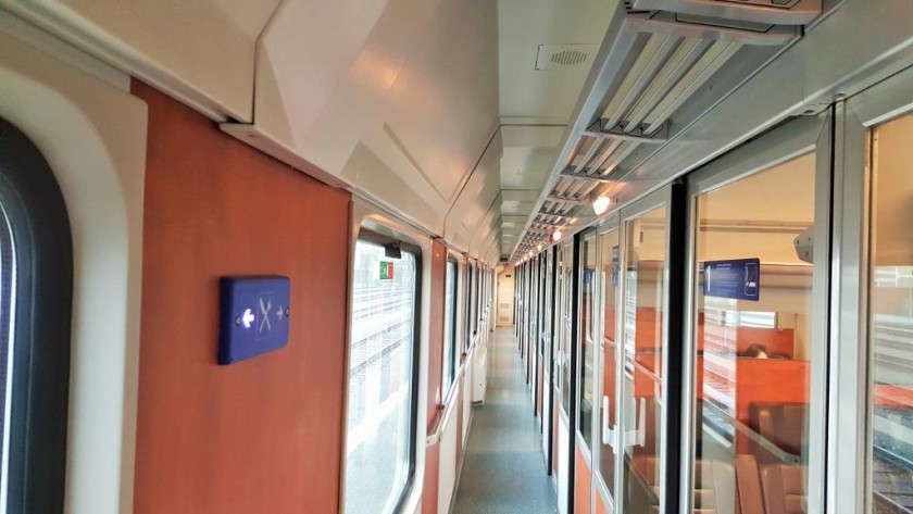 The corridor in a 1st class coach that has seating compartments