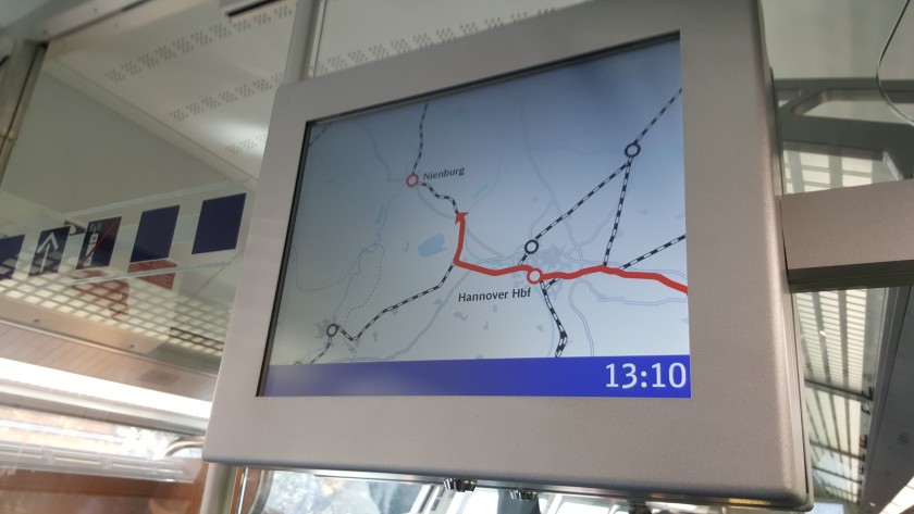 The info screens show the train's current location