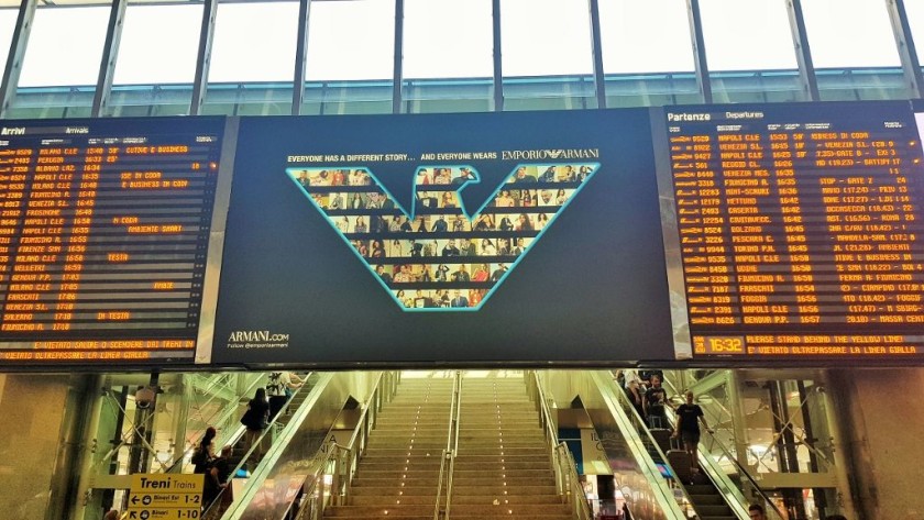 The main departure board at Roma Termini - the steps lead up to a terrace of cafés