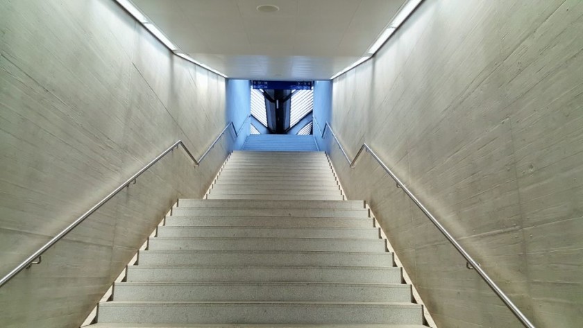 There are stairs and escalators linking the shopping concourse to the platforms in the main station