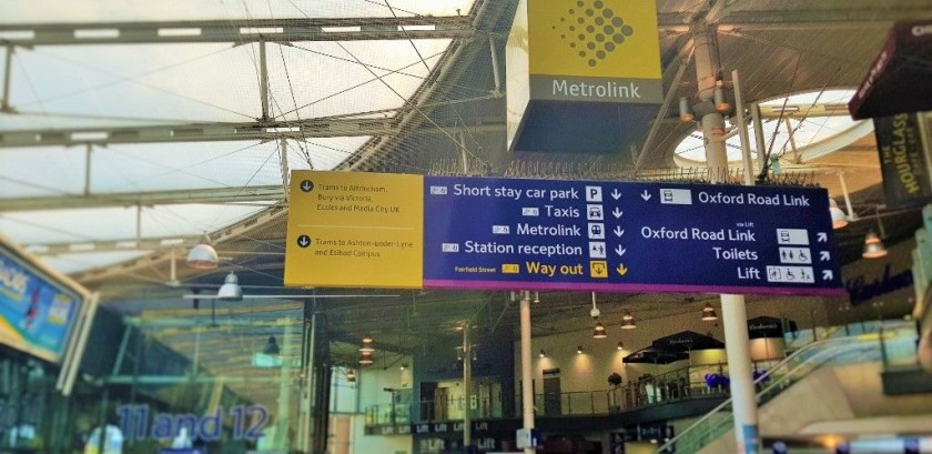 Under the Metrolink signs are the escalators down to the tram stops and taxi rank