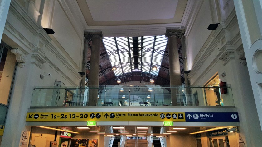 From the main hall, the escalators under these signs lead up to the main exit