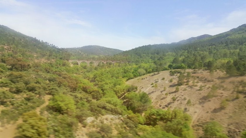 The train rushes between tunnels and viaducts north of Cordoba