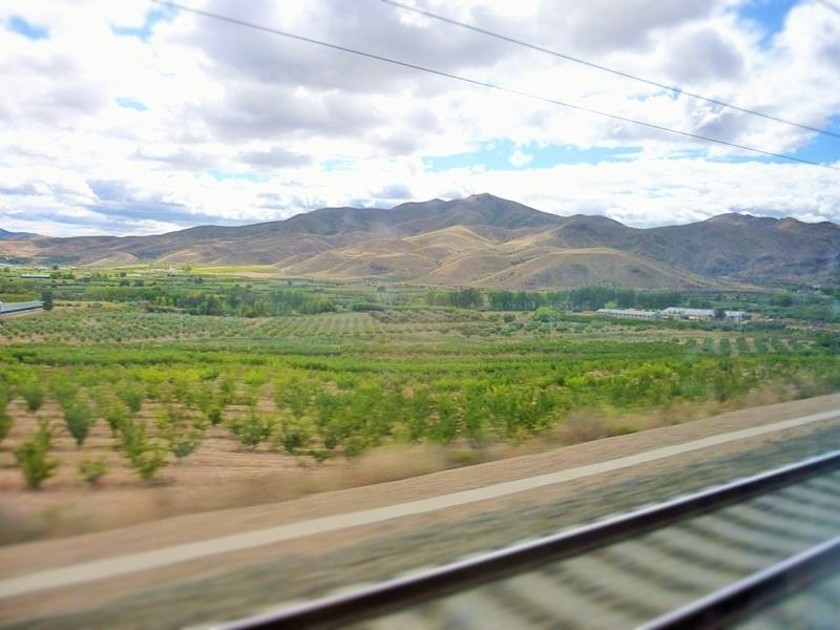 There are frequent distant view of mountains from both sides of the train