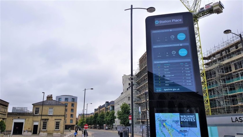 The bus info display, but the stops are on the other side of the white building over to the right