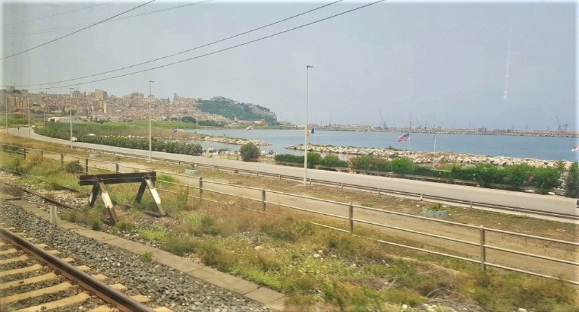 Arriving in Bagheria where the town looms over the railway