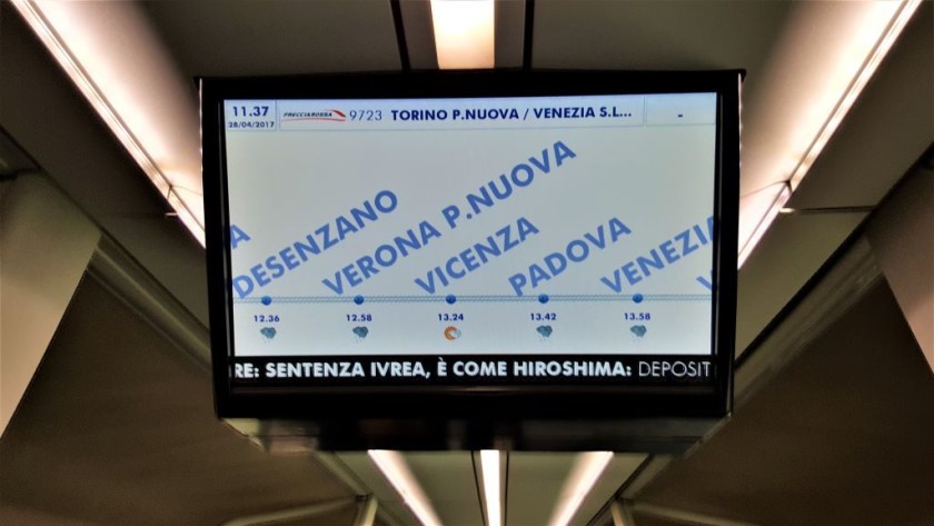 The info on an Italian Frecce trains, shows the station calls, arrival times and the local weather