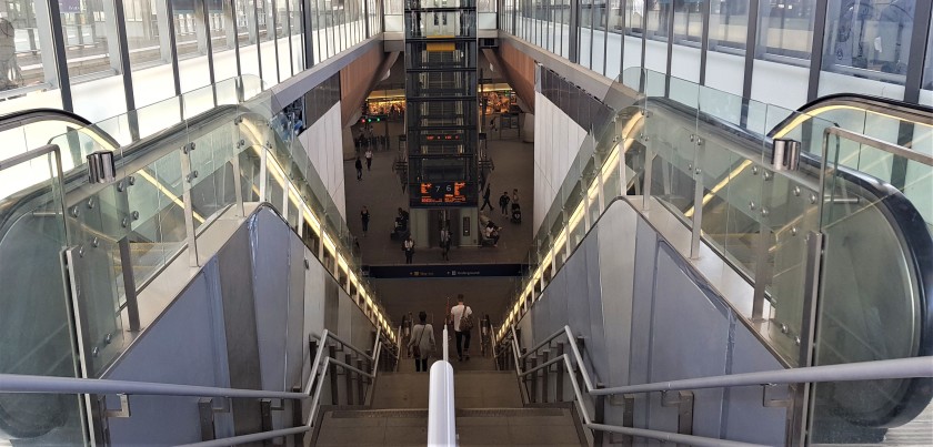 One of the sets of stairs and escalators down to the lower concourse, go passed these entrances to access the elevators