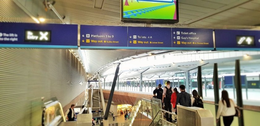 The top of the escalator down to the lower concourse from the upper concourse is to the left of platform 10