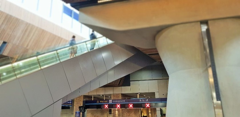 the passage to the Underground is somewhat hidden behind the escalator to the upper concourse