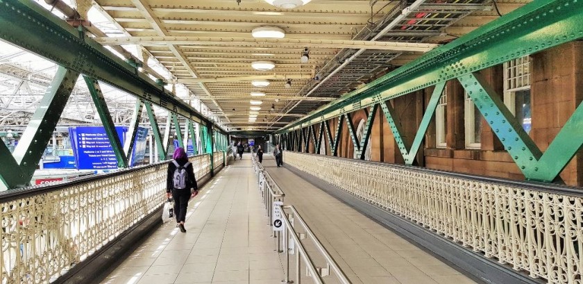 On the left of the bridge escalators go down to the main concourse, platforms 1 and 20 are at the far end