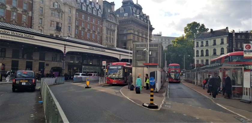 The bus stands in front of Victoria railway station