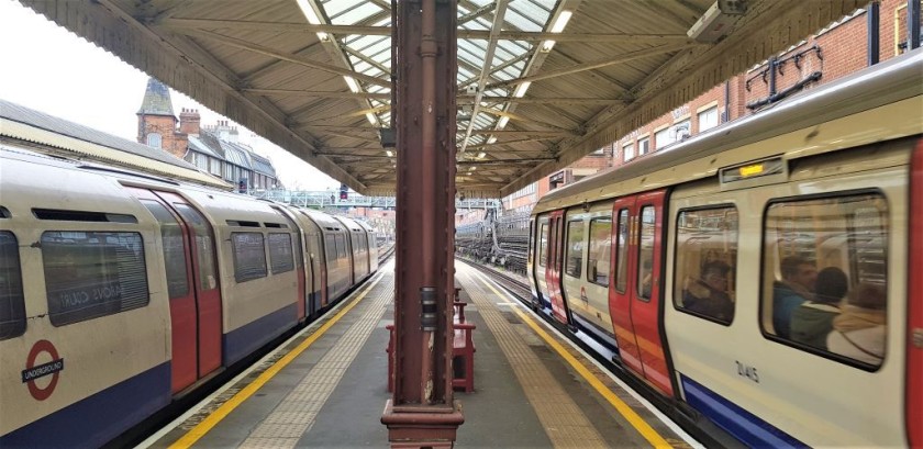 A tube train on the left and a sub-surface train on the right