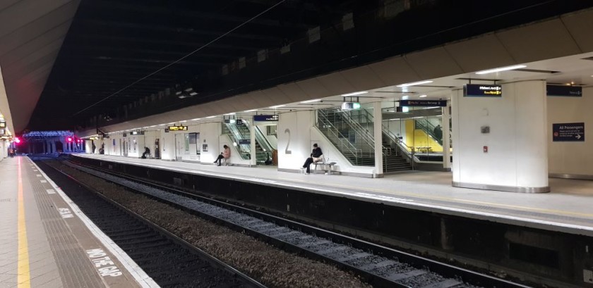 These people at the 'a' ends are sitting between the stairs, the escalators and the lift