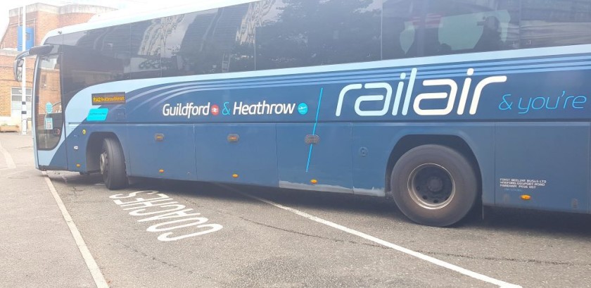 A bus to Heathrow departs from the Woking station forecourt