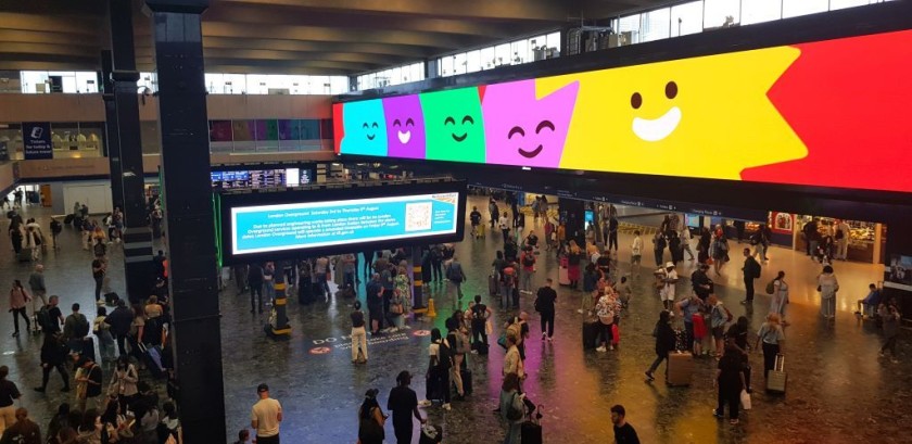 The access to the trains is on the other side of the advertising screen