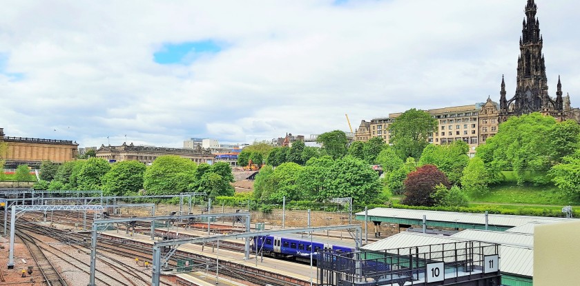Looking over Edinburgh Waverley station tp Princes Street Gardens and the Scott Monument