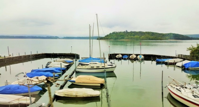 The trains travel by the shore of the lake between Neuchatel and Biel