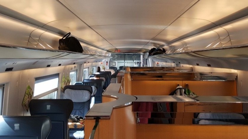 A view of a 1st class interior with the semi-open compartments to the right
