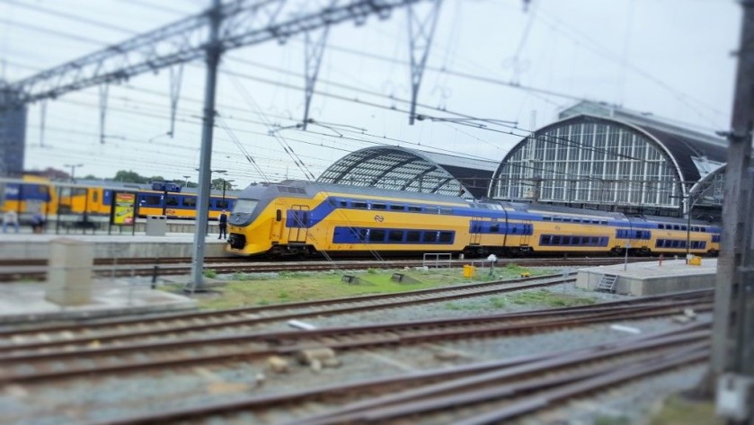 An NS VIRM train departs from Amsterdam