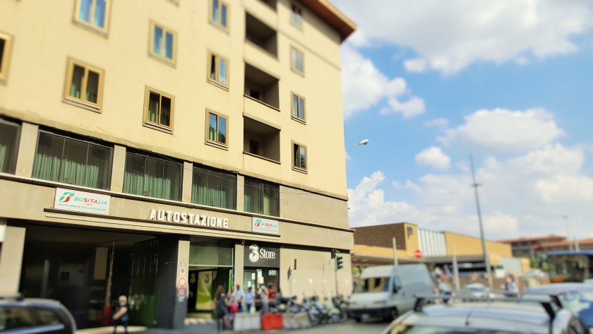 The main bus station entrance with the train station in the background