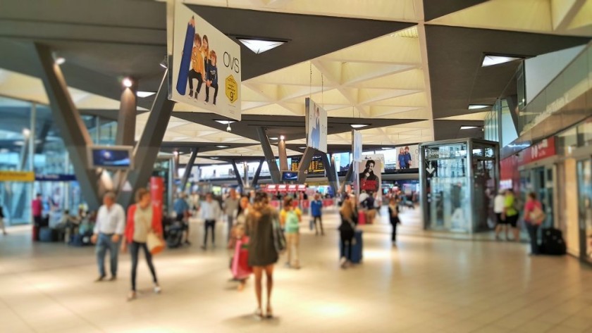 The platforms used by the long-distance trains lead off the concourse, they're behind the yellow departure board