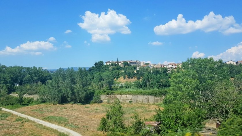 Flashing past one of the many villages that the train will pass