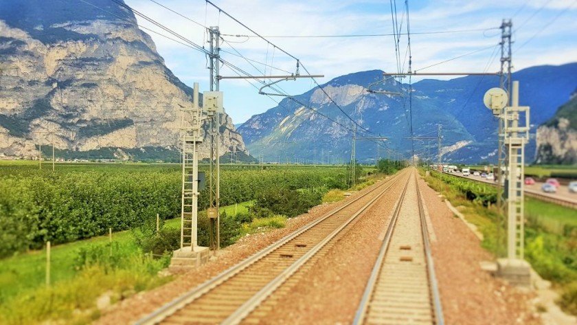 Looking out the rear window of a train as it heads through the valley north of Trento