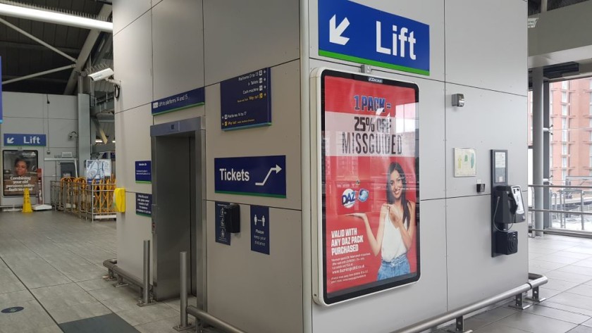 An elevator on the bridge down to a set of platforms, which passengers with luggage are instructed to use