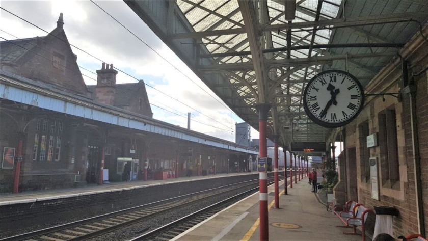 By the clock on the northbound platform is the entrance to a subway, which is the quickest route to the exit