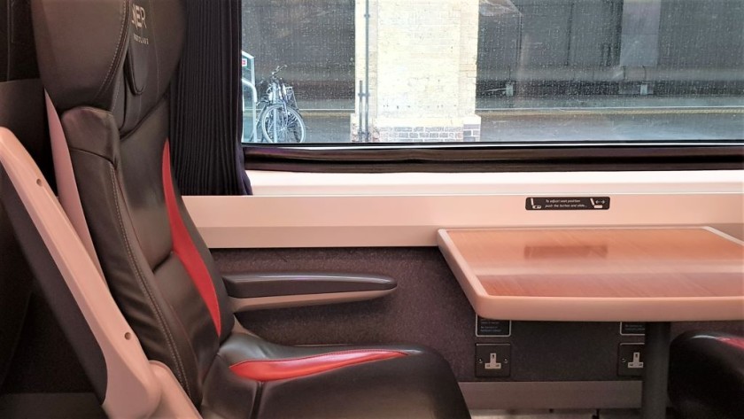 All First Class seats have tables (note the power sockets under the tables)