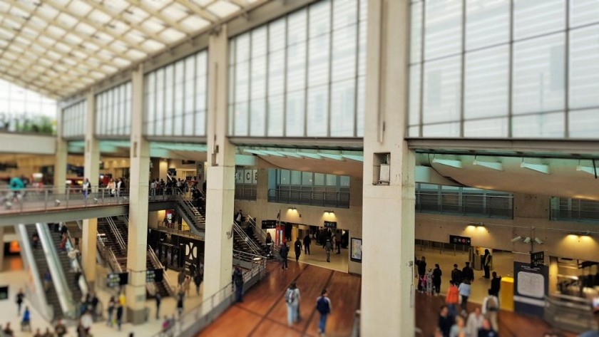 The escalators on the left of the concourse lead down towards the Metro