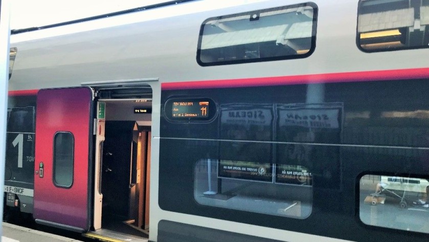 A close up of a door to a TGV Océane coach showing the electronic info panel