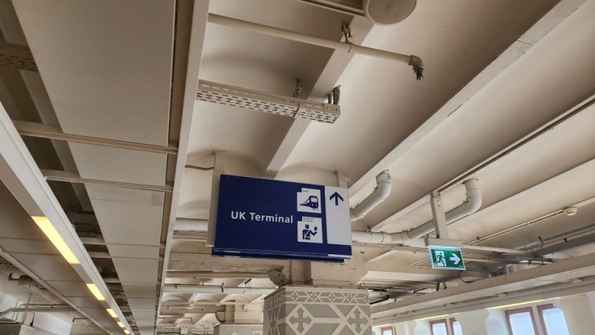 Signs which point the way to the UK Terminal at Amsterdam Centraal