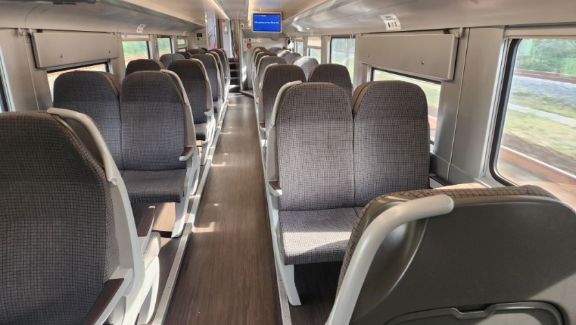 A lower deck 2nd class seating saloon on a Belgian IC train