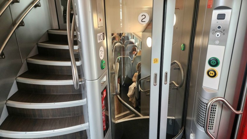 The stairs to the lower and upper deck seating saloons on a Belgian IC train