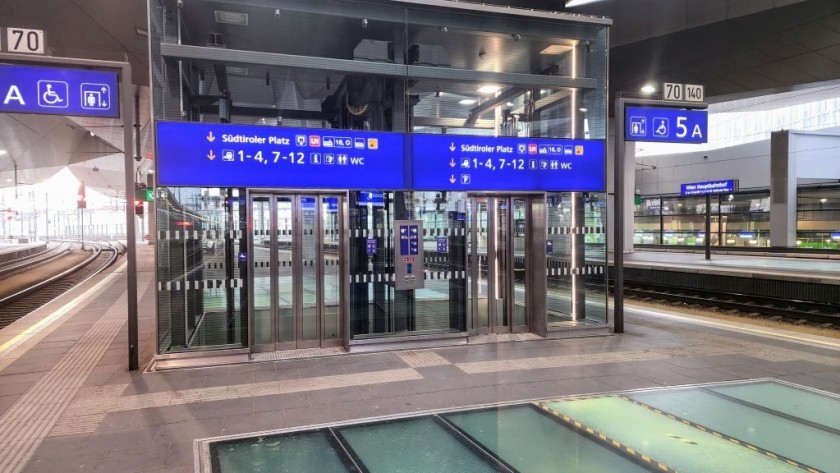 The elevators down to the main exits are on zone A, on the platforms, so they'll likely be beyond the escalators