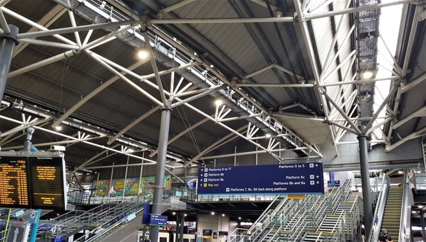 The escalators/stairs on the right are straight ahead from the ticket gates