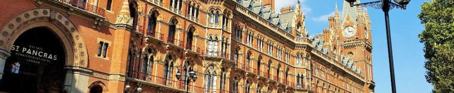 The magnificence of St Pancras station on Euston Road, the most romantic entrance is the arch by the red car