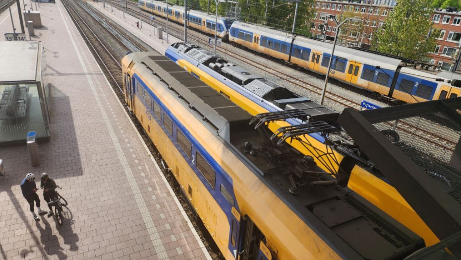 Trains meet tram at Den Haag Centraal