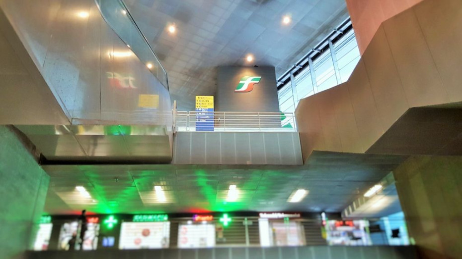 The atrium which houses the escalators that link street level to the bridge which spans the station