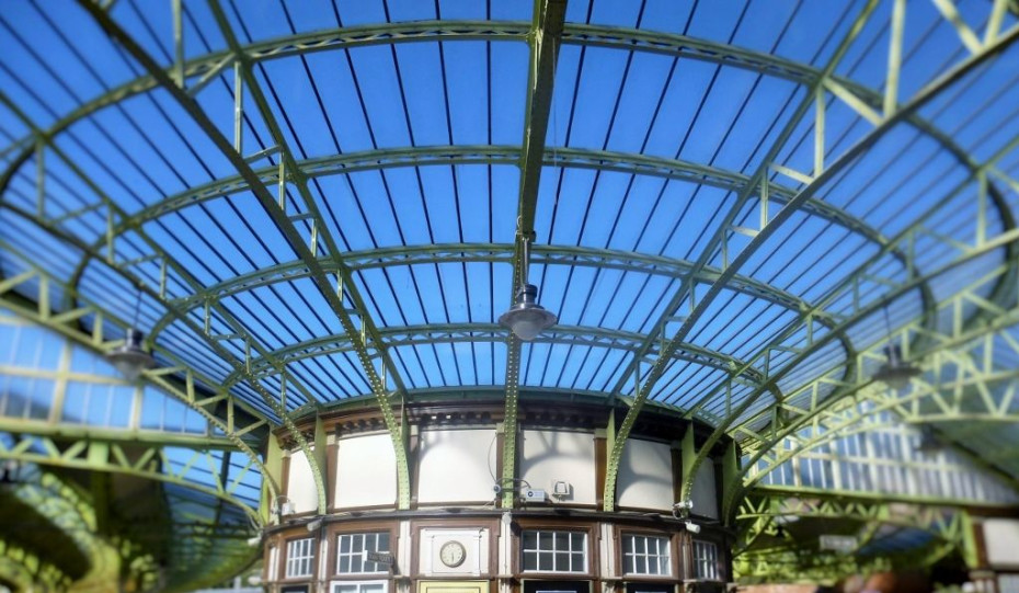 The prettiest station ticket office in Britain supports the elegant roof
